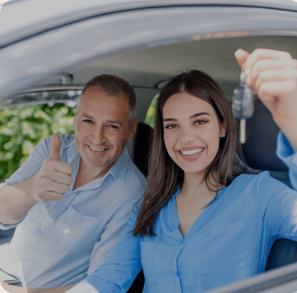 Young woman delighted having just passed her driving test.